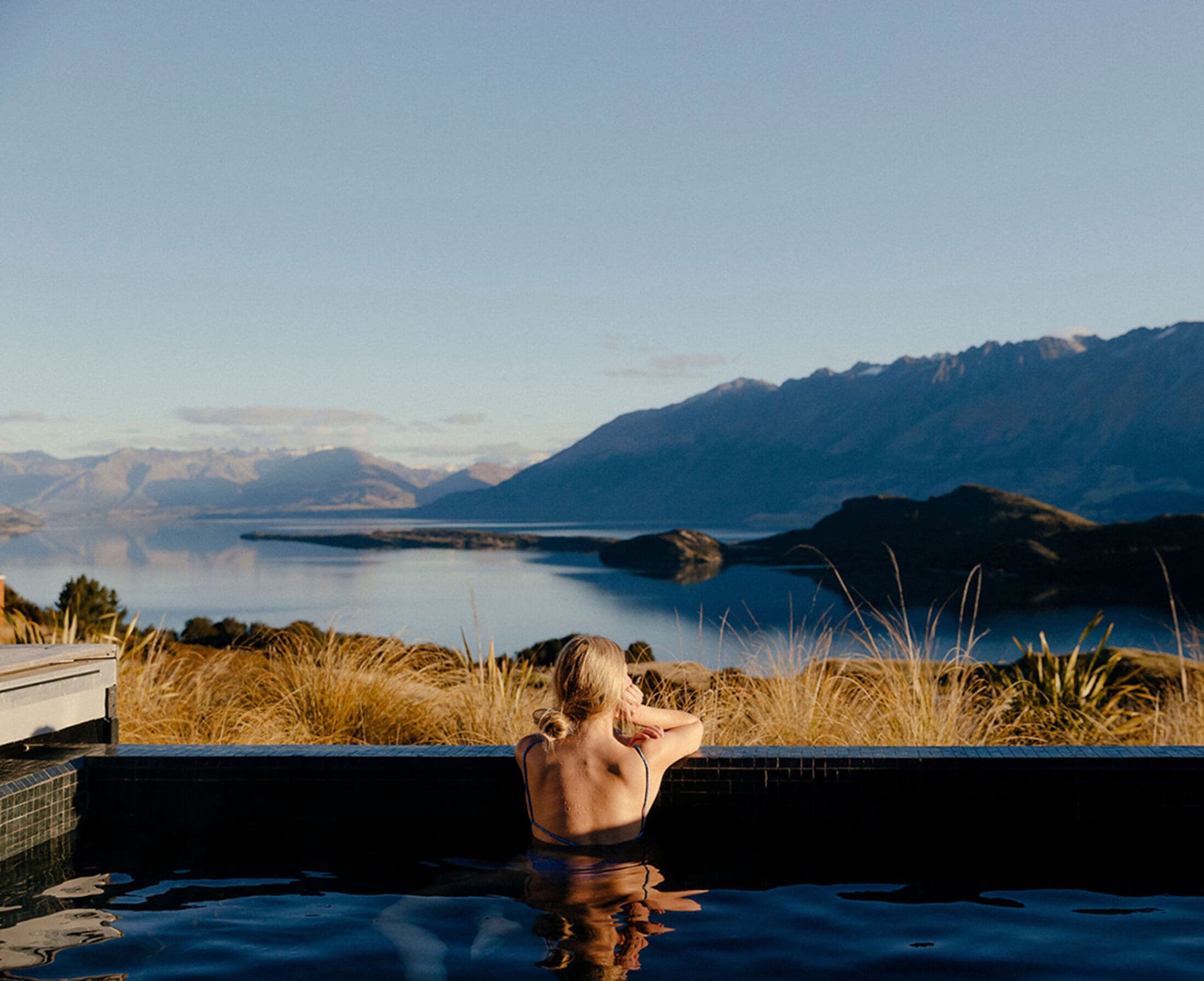 Aro Hā's pool looking across Lake Wakatipu to the mountains at dusk